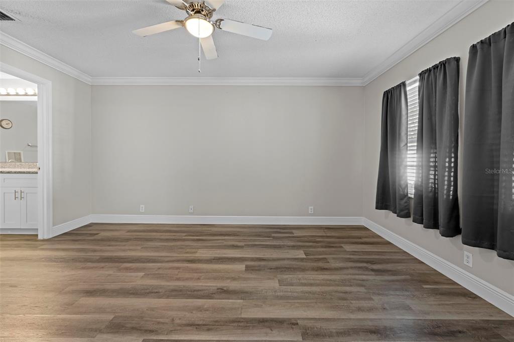 8155 Giffen Lane Spring Hill, FL 34608 - Photo 22 of 52 a view of an empty room with wooden floor and a window