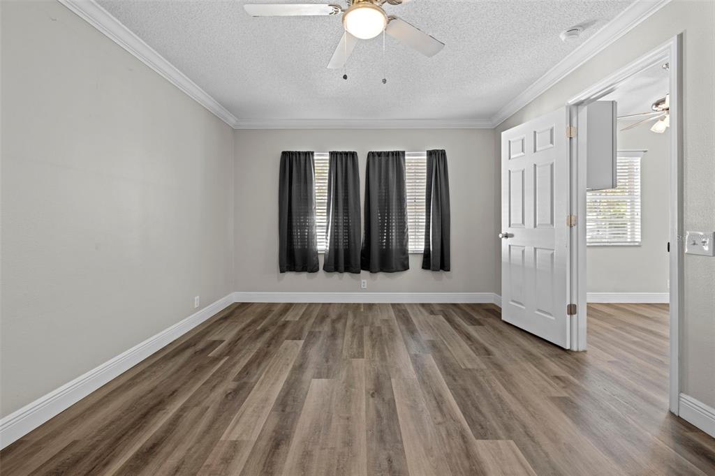 8155 Giffen Lane Spring Hill, FL 34608 - Photo 23 of 52 a view of an empty room with wooden floor and a window
