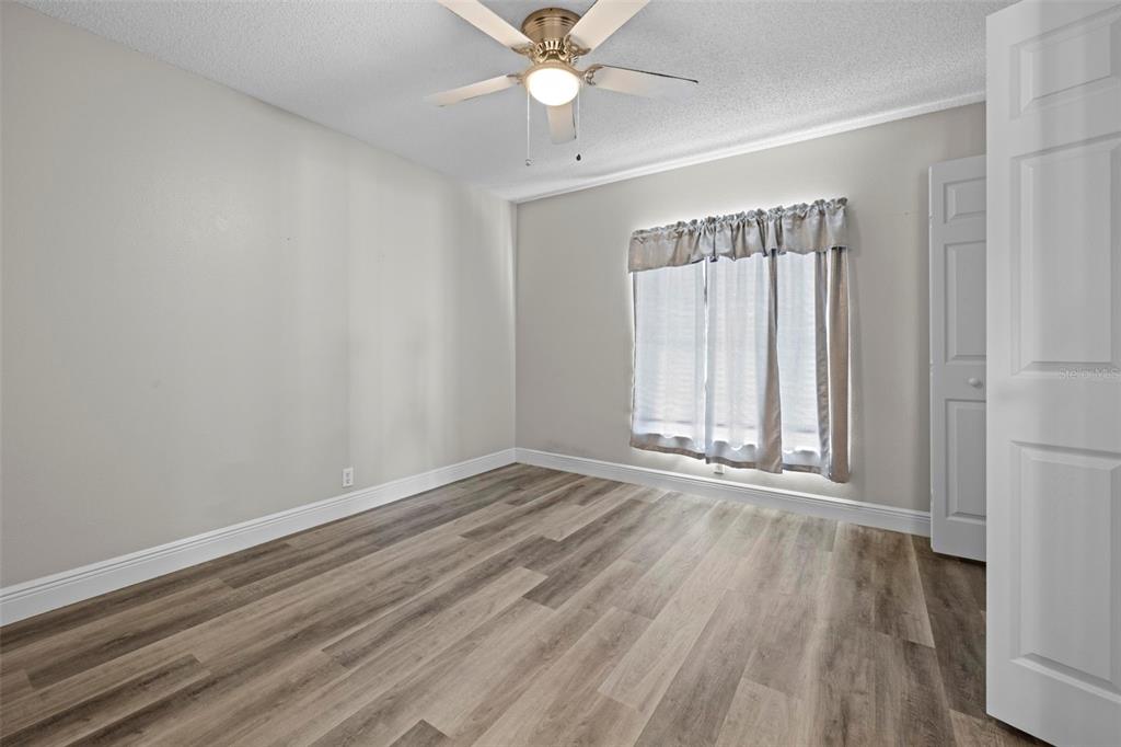 8155 Giffen Lane Spring Hill, FL 34608 - Photo 25 of 52 wooden floor in an empty room with a window
