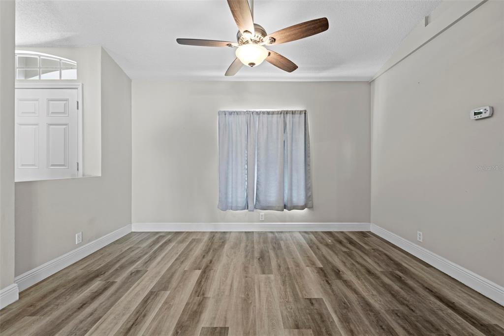 8155 Giffen Lane Spring Hill, FL 34608 - Photo 27 of 52 a view of room with hardwood floor and a ceiling fan