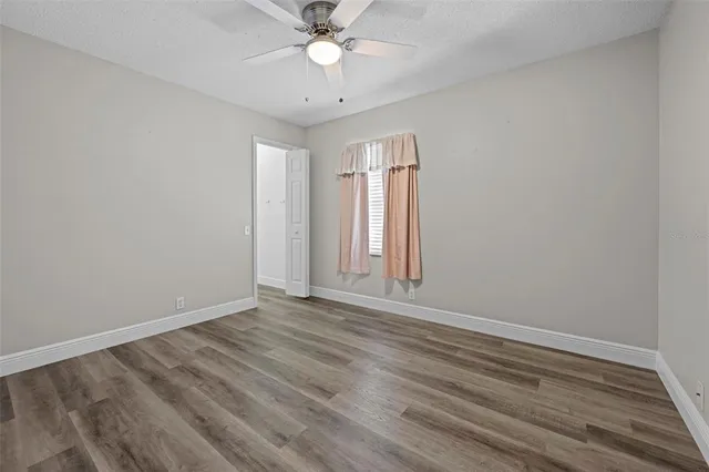 a view of a room with wooden floor and a window