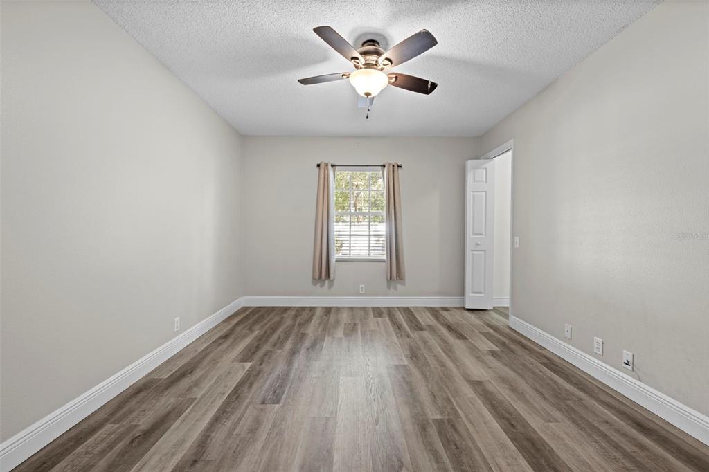 8155 Giffen Lane Spring Hill, FL 34608 - Photo 33 of 52 wooden floor in an empty room with a window