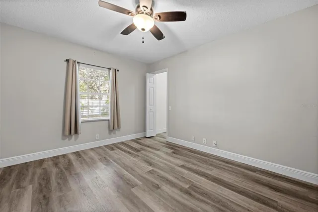 a view of room with ceiling fan and window