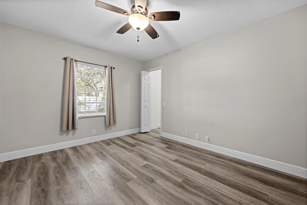 8155 Giffen Lane Spring Hill, FL 34608 - Photo 34 of 52 wooden floor in an empty room with a window