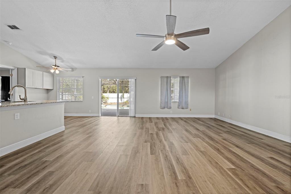 8155 Giffen Lane Spring Hill, FL 34608 - Photo 9 of 52 a view of empty room with wooden floor and window