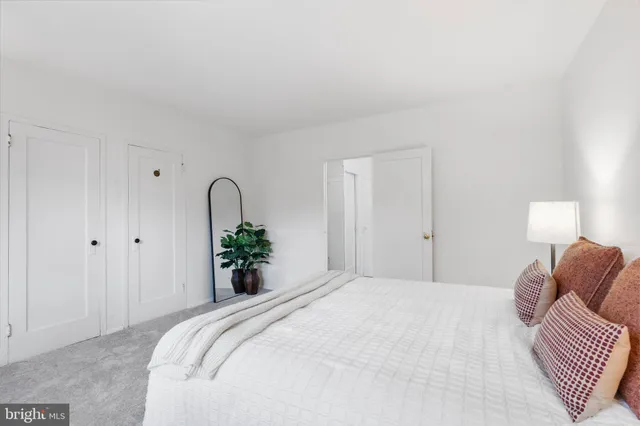 a bedroom with a bed and a lamp