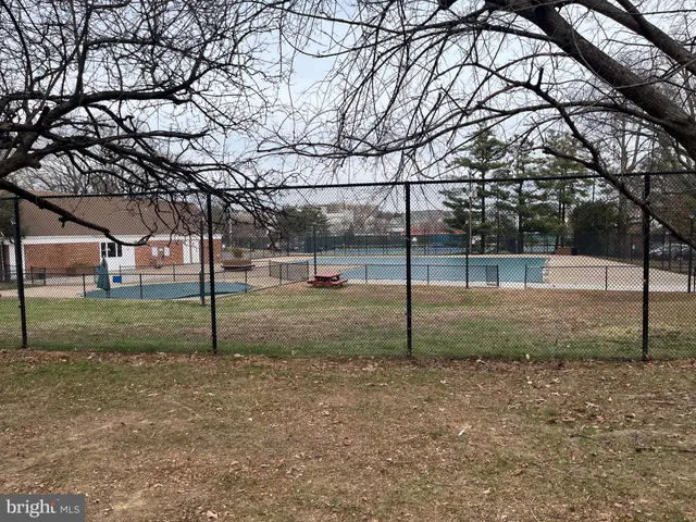a front view of house with yard and trees around