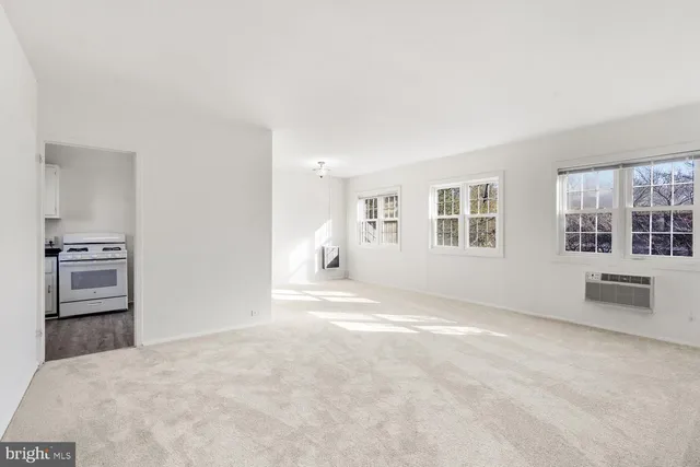 a kitchen with granite countertop a sink a stove and cabinets