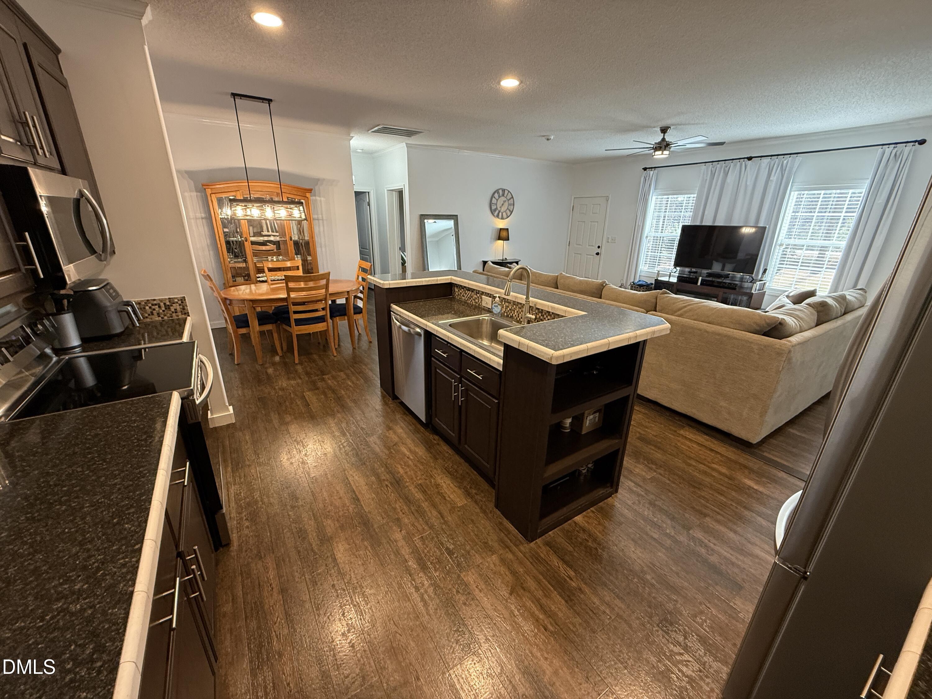 11242 Bissette Road Middlesex, NC 27557 - Photo 13 of 49 a kitchen with a stove and wooden floor