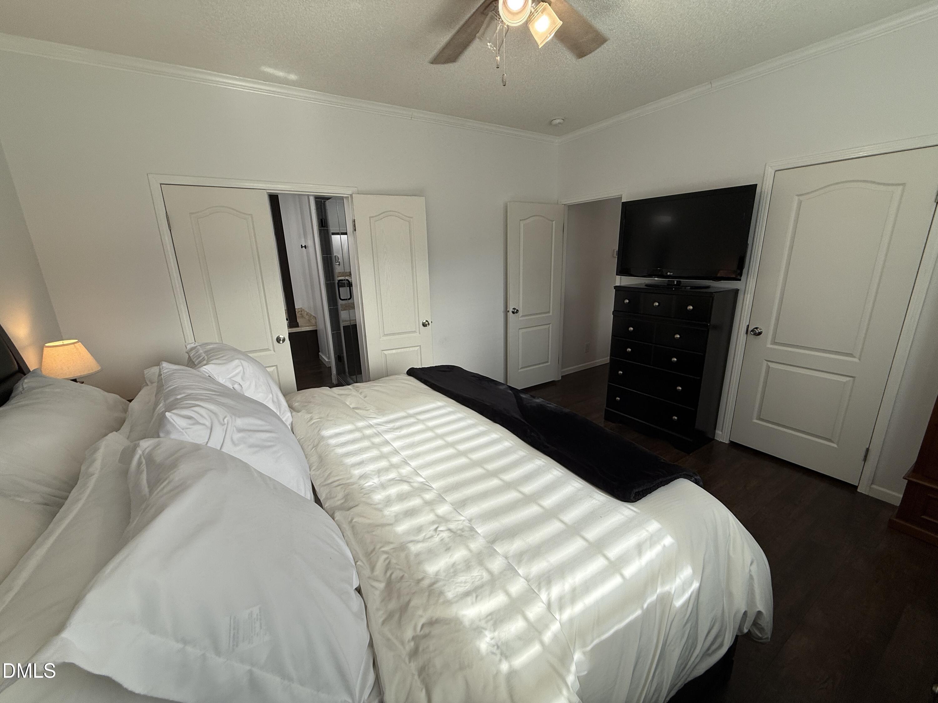 11242 Bissette Road Middlesex, NC 27557 - Photo 16 of 49 a bedroom with a bed and a television