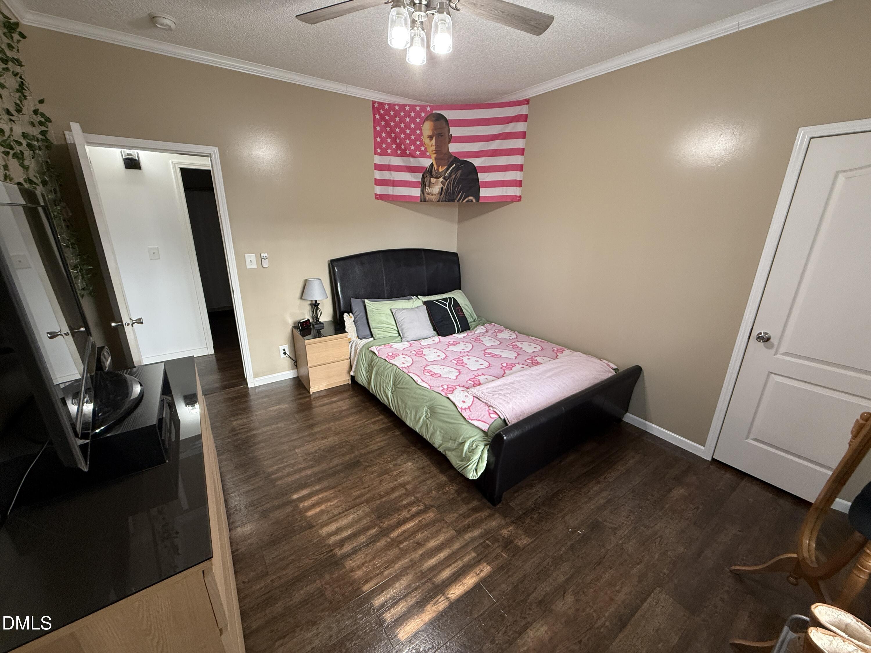 11242 Bissette Road Middlesex, NC 27557 - Photo 22 of 49 a bedroom with a bed and a flat tv screen on a dresser