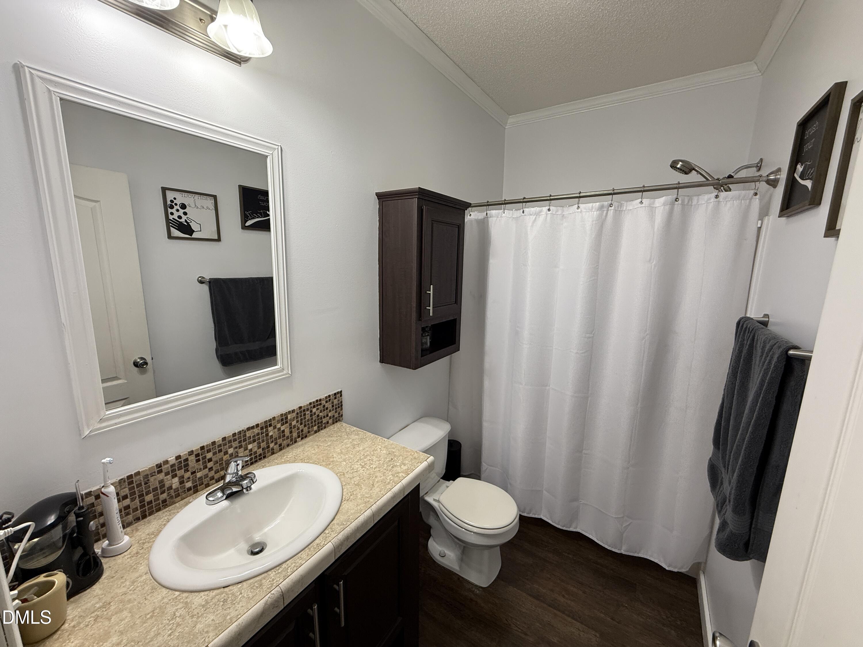 11242 Bissette Road Middlesex, NC 27557 - Photo 25 of 49 a bathroom with a sink toilet and shower