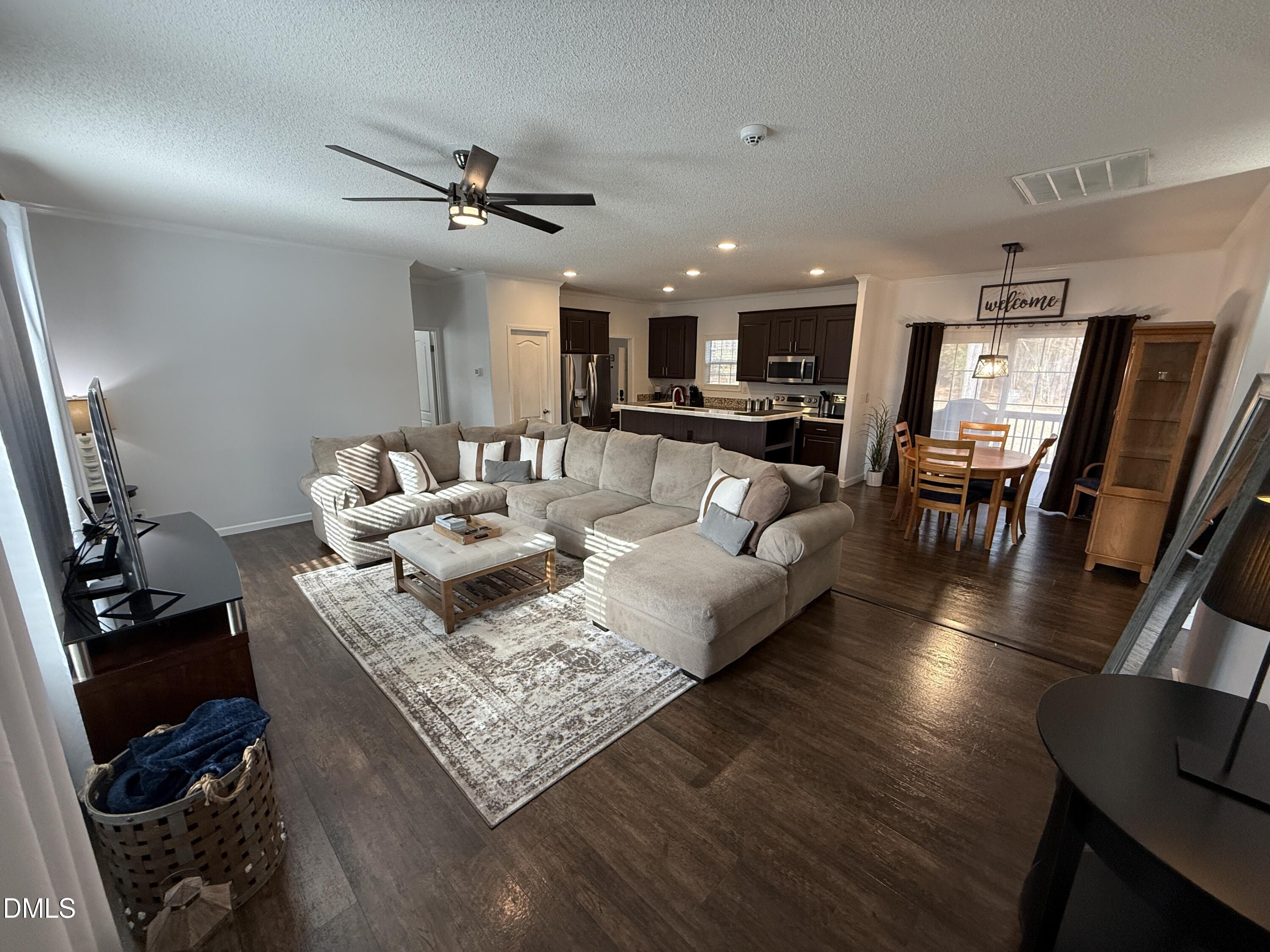 11242 Bissette Road Middlesex, NC 27557 - Photo 6 of 49 a living room with furniture and a wooden floor