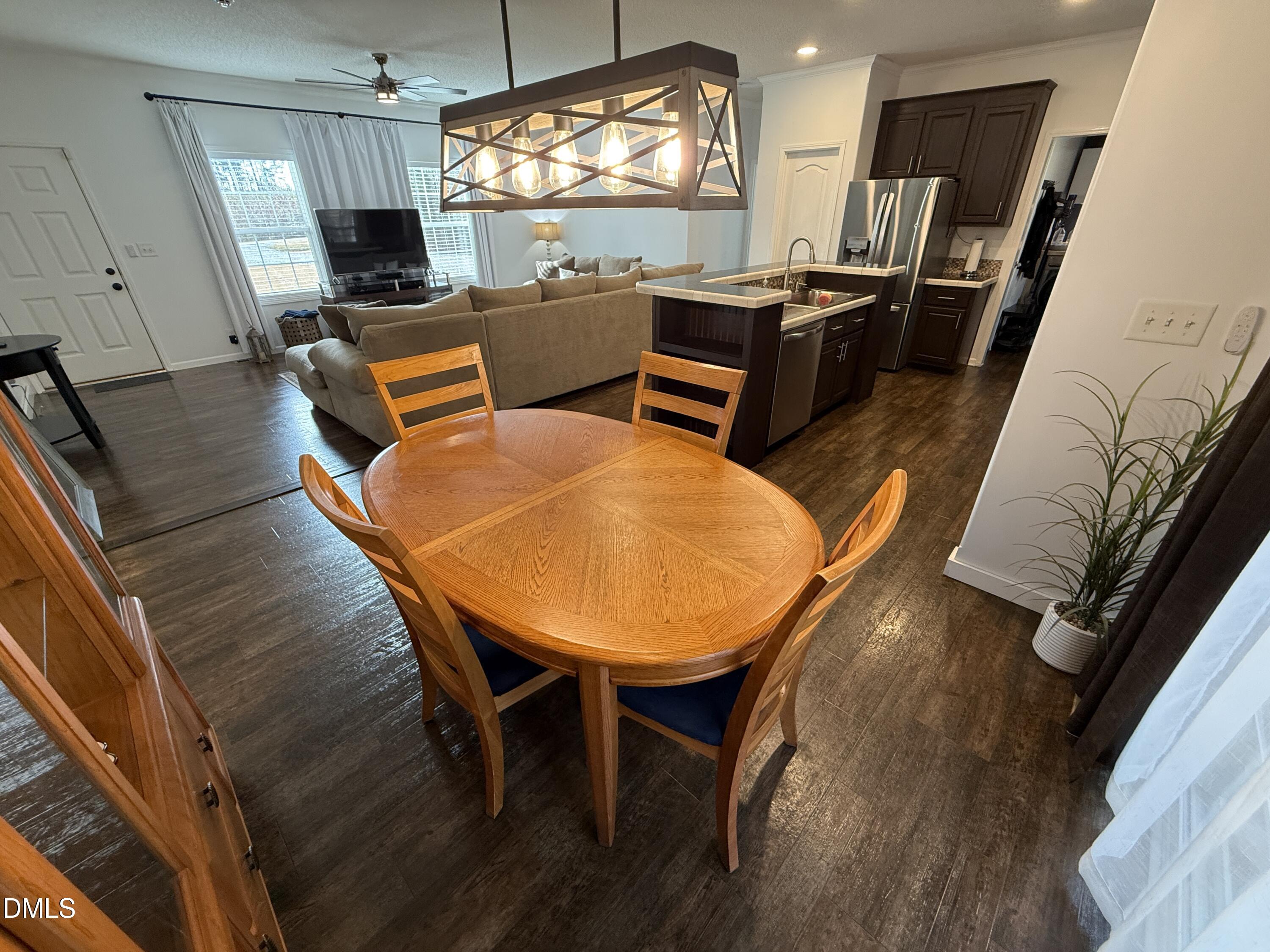 11242 Bissette Road Middlesex, NC 27557 - Photo 9 of 49 a living room with chairs a flat screen tv and next to a window