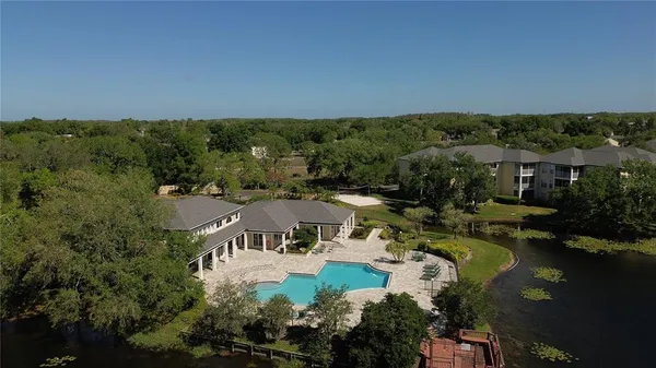 an aerial view of a house outdoor space and swimming pool