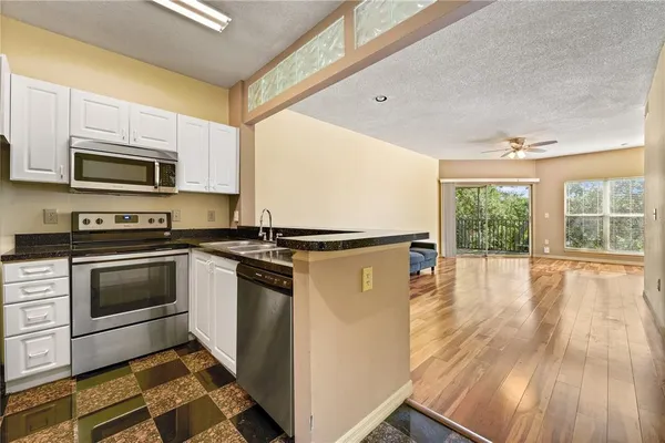 a white refrigerator freezer and a stove sitting inside of a kitchen