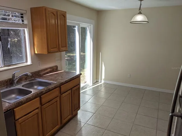 a kitchen with a sink stove and cabinets