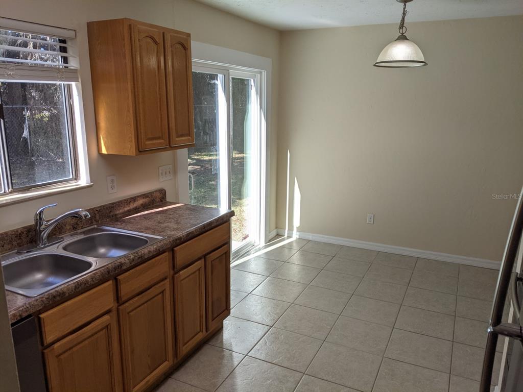 322 Canal Road, Unit D26 Edgewater, FL 32132 - Photo 3 of 9 a kitchen with a sink stove and cabinets