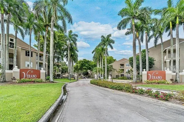 a front view of multiple houses with yard