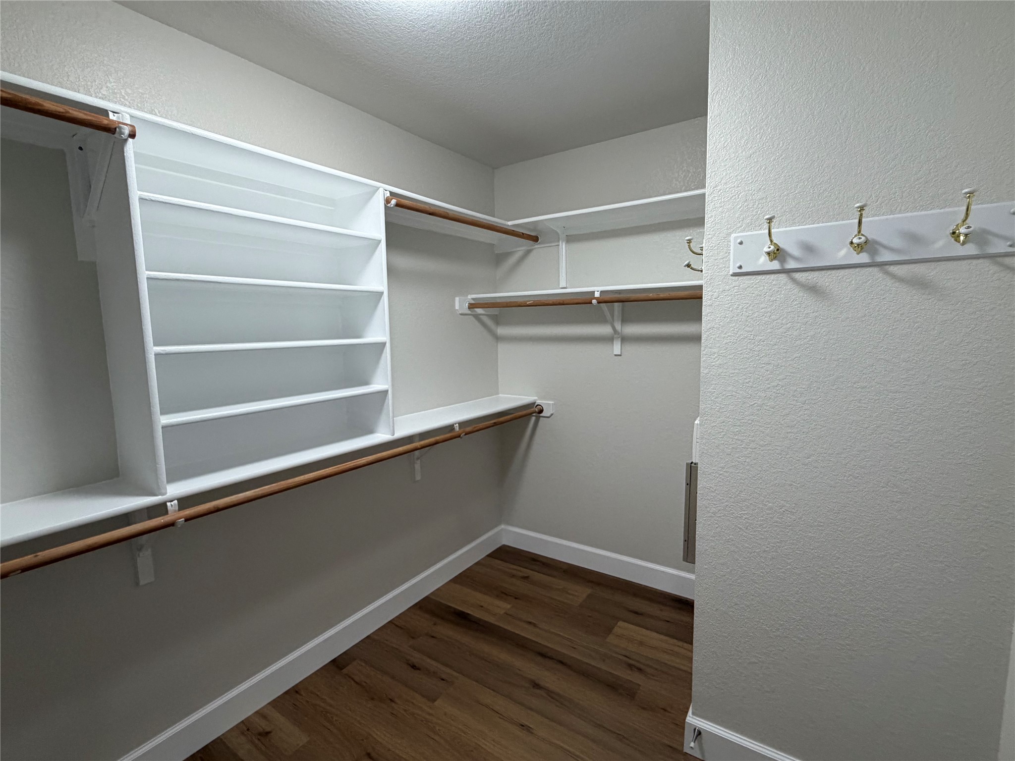 4604 Ramies Run Austin, TX 78749 - Photo 25 of 38 Ample built-in shelving and warm wood floors define this functional walk-in closet space.