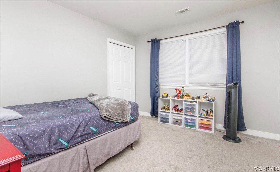 12906 Lewis Road Chesterfield, VA 23831 - Photo 12 of 22 a bedroom with a bed and a cabinets