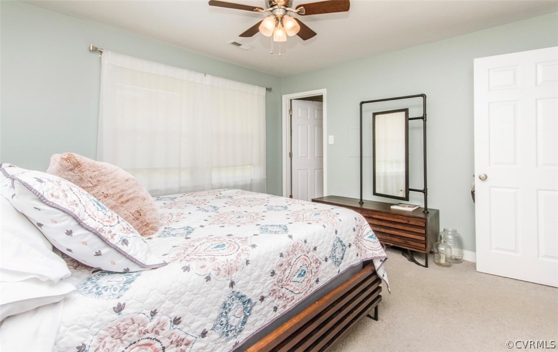 12906 Lewis Road Chesterfield, VA 23831 - Photo 16 of 22 a bedroom with a bed and a chandelier