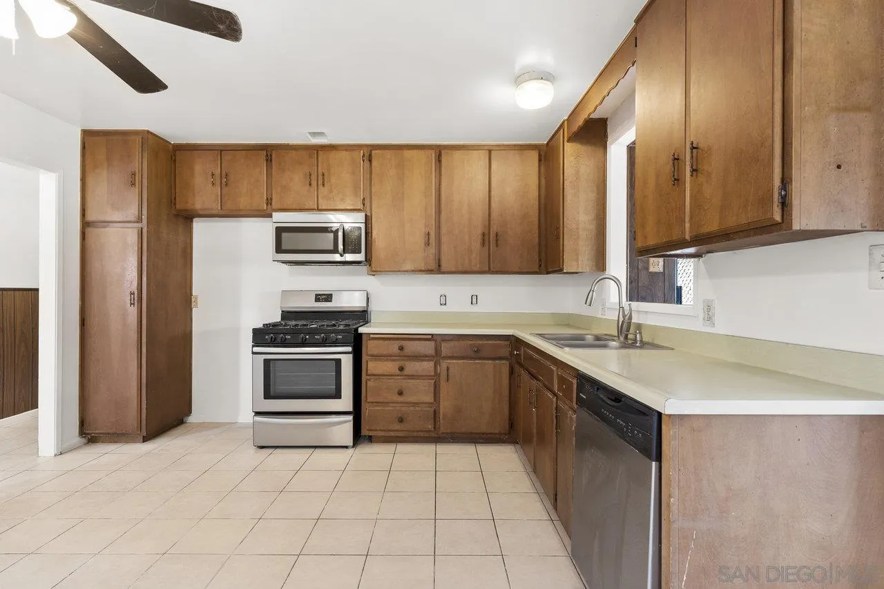 582 Macon Street El Cajon, CA 92019 - Photo 14 of 34 a kitchen with a sink stove and refrigerator
