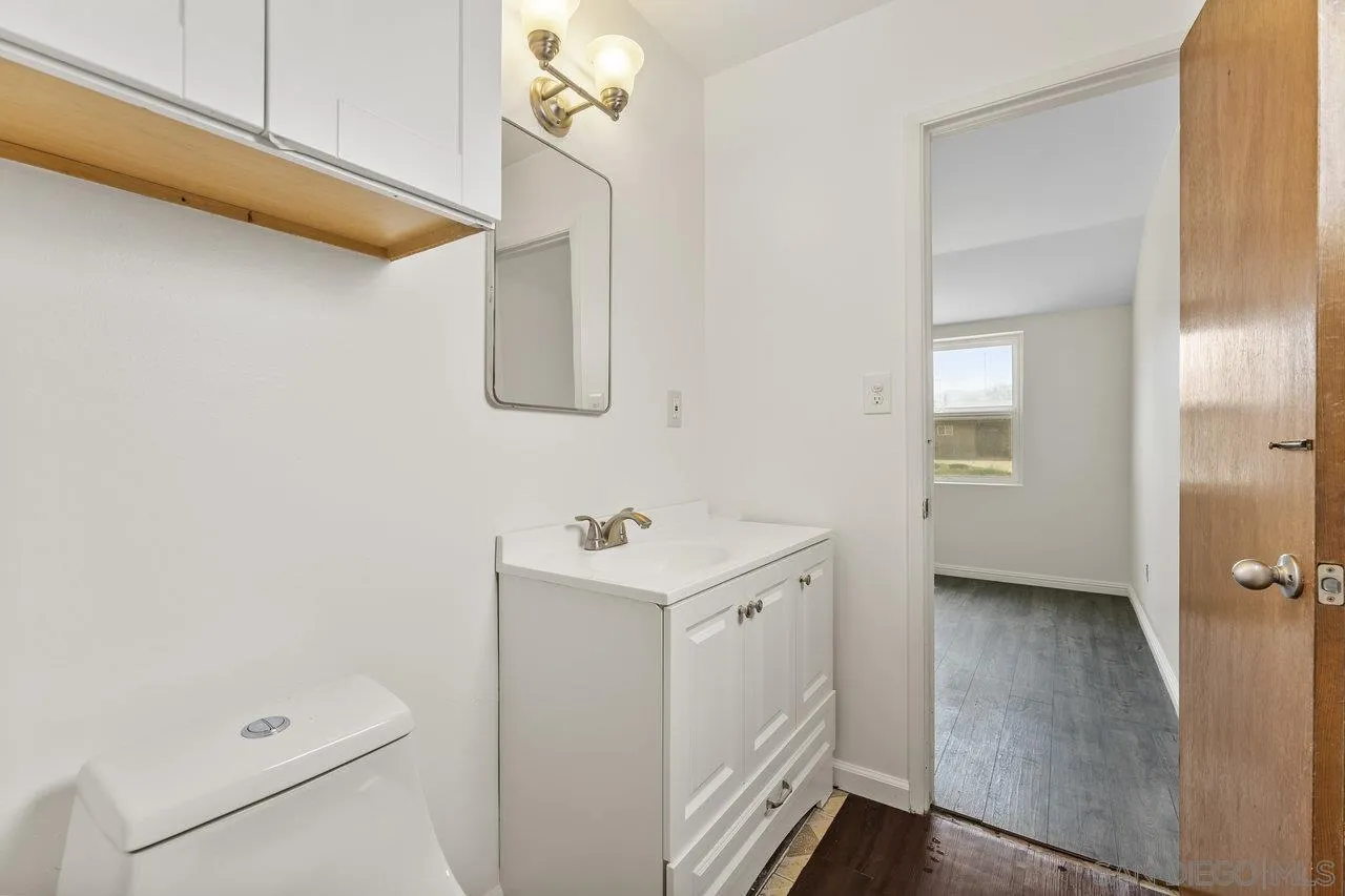 582 Macon Street El Cajon, CA 92019 - Photo 18 of 34 a bathroom with a sink a mirror and a shower