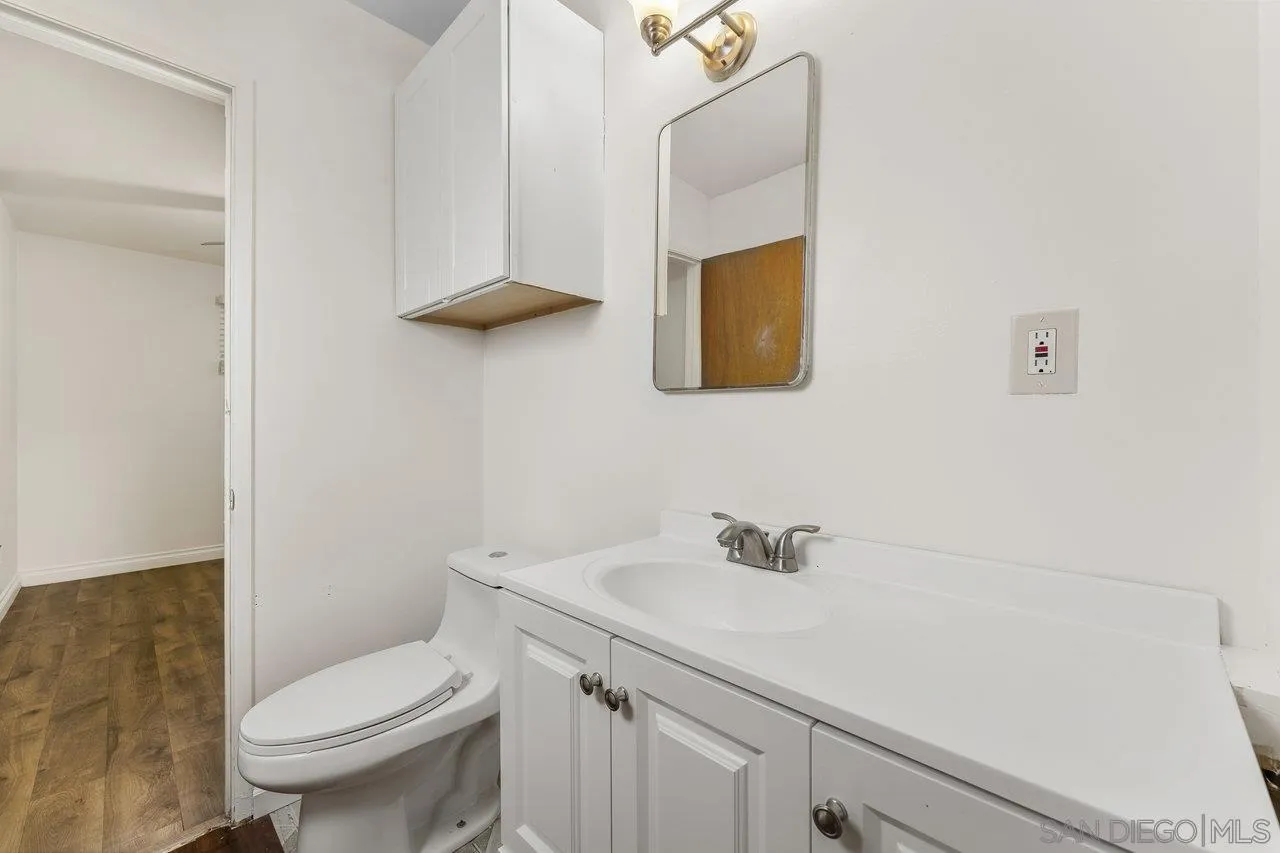 582 Macon Street El Cajon, CA 92019 - Photo 19 of 34 a bathroom with a sink a toilet and mirror