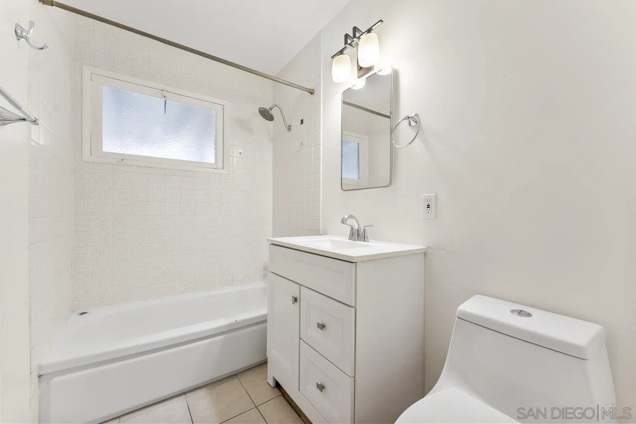 582 Macon Street El Cajon, CA 92019 - Photo 23 of 34 a bathroom with a sink a toilet and shower
