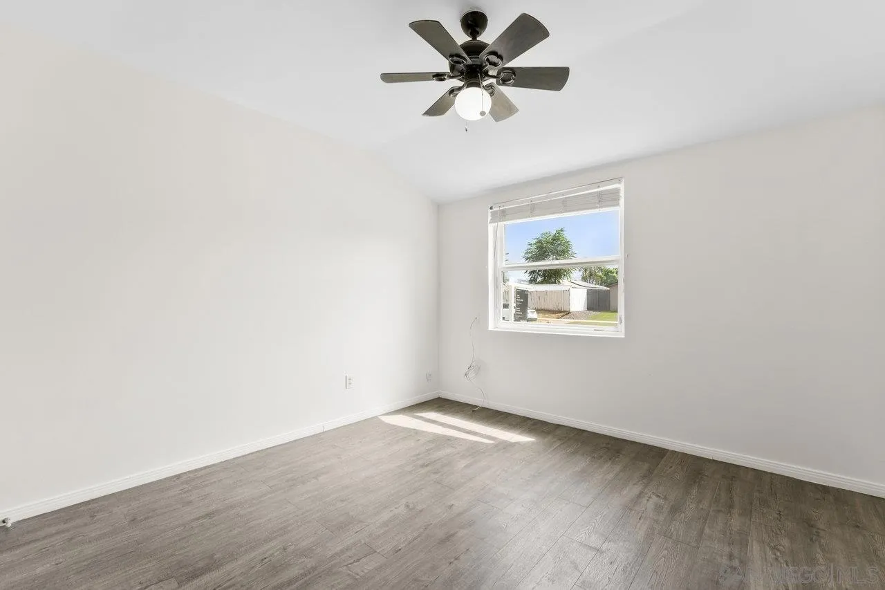 582 Macon Street El Cajon, CA 92019 - Photo 25 of 34 an empty room with a window and a fan