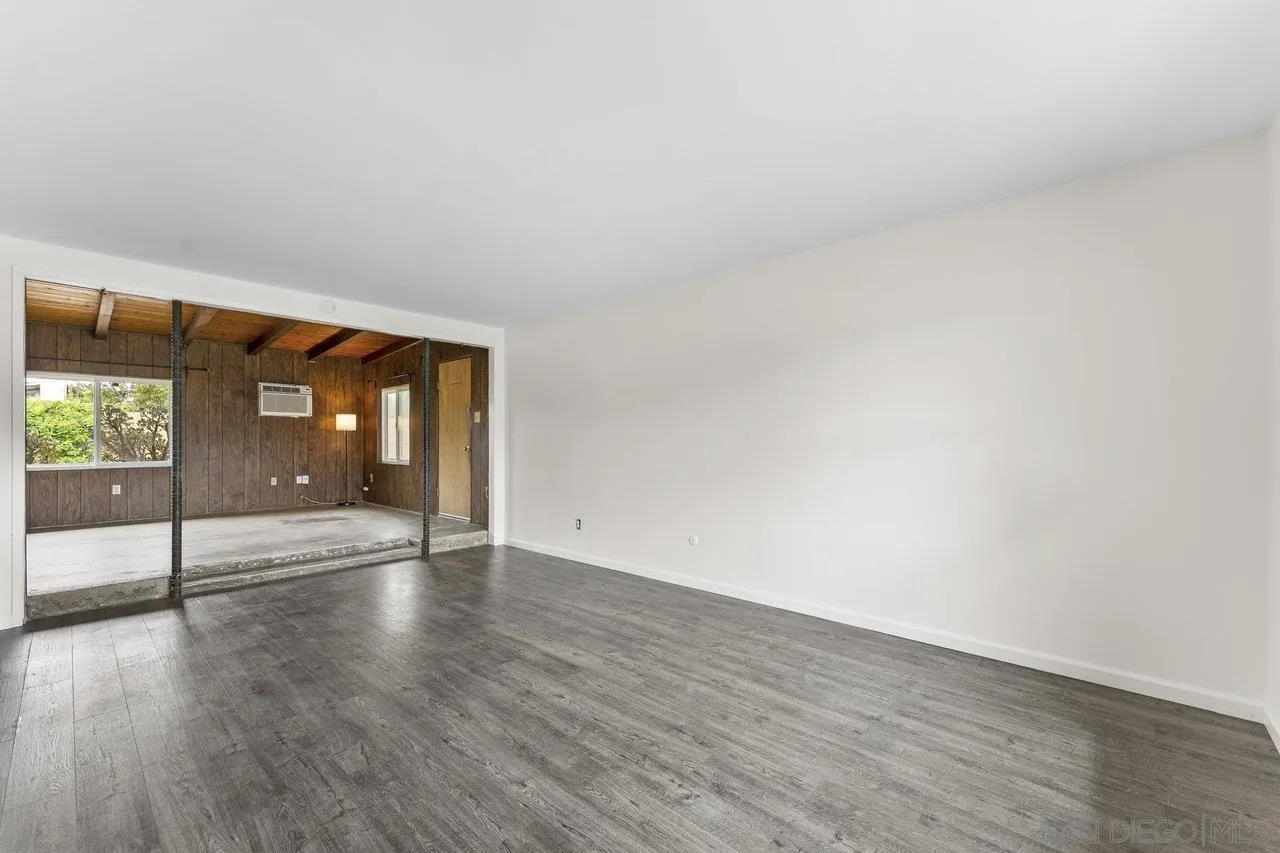 582 Macon Street El Cajon, CA 92019 - Photo 5 of 34 a view of an empty room with wooden floor and a window