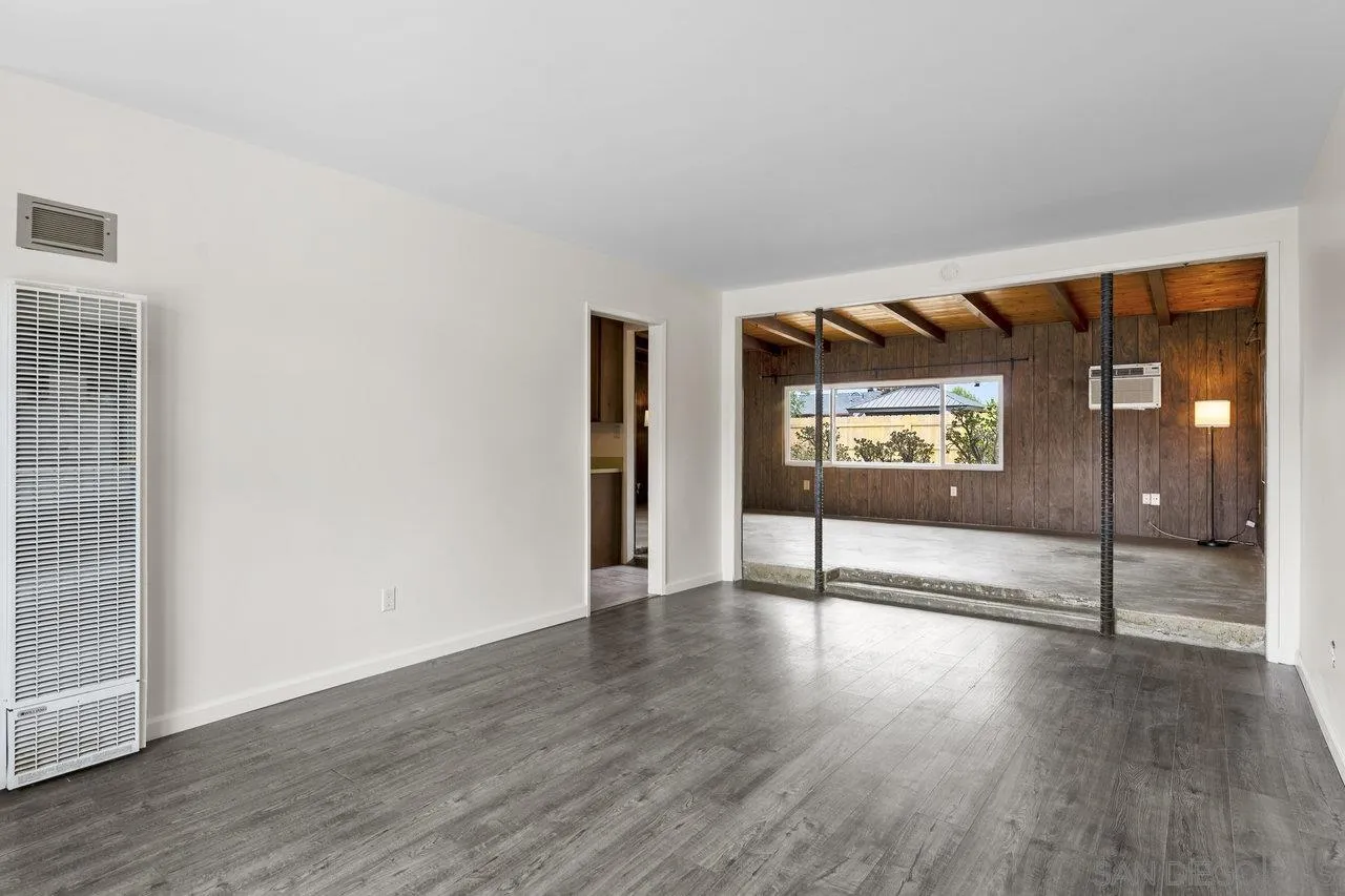 582 Macon Street El Cajon, CA 92019 - Photo 7 of 34 a view of an empty room with window and wooden floor