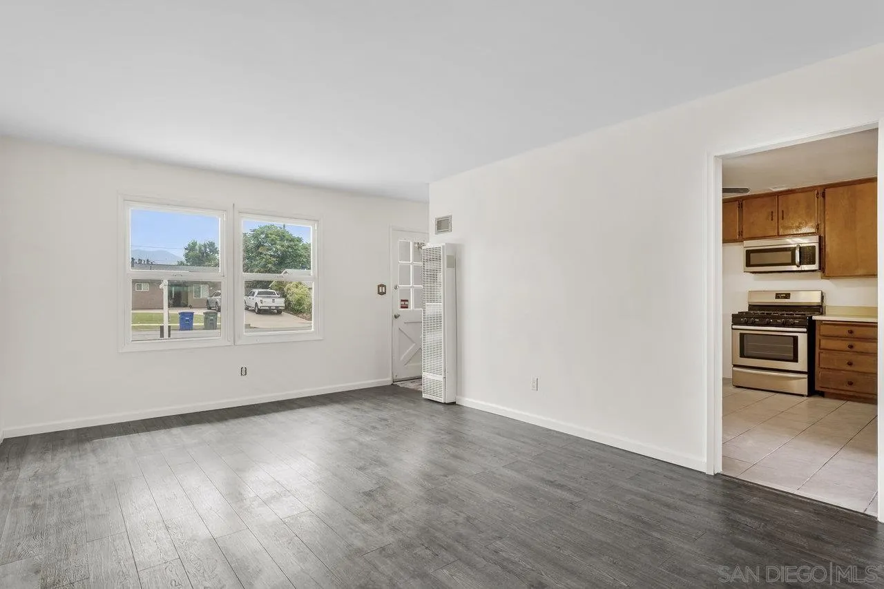 582 Macon Street El Cajon, CA 92019 - Photo 8 of 34 an empty room with wooden floor and windows