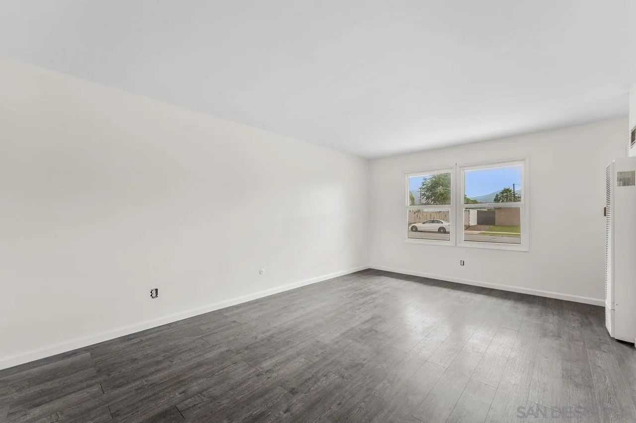 582 Macon Street El Cajon, CA 92019 - Photo 9 of 34 a view of an empty room with wooden floor and a window