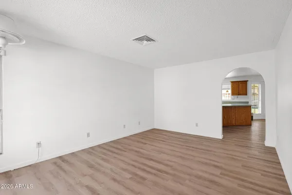 a view of a kitchen with wooden floor and a sink