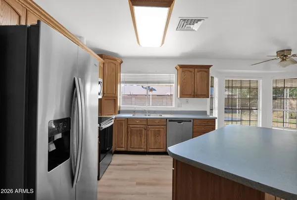 a kitchen with stainless steel appliances granite countertop a refrigerator and a sink