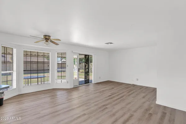 wooden floor in an empty room with a window