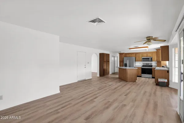 a view of a kitchen with a sink and a refrigerator