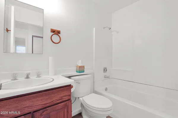 a bathroom with a sink toilet a mirror and shower