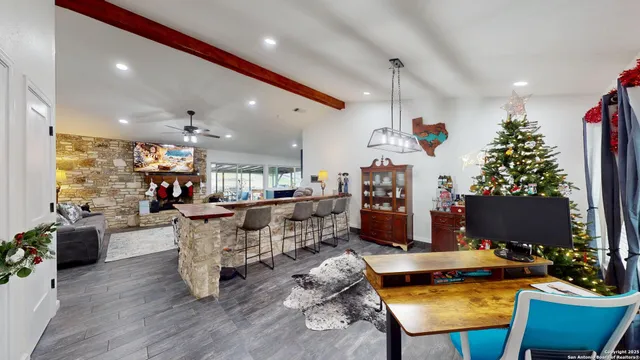 a living room with furniture a dining table and a floor to ceiling window or potted plant