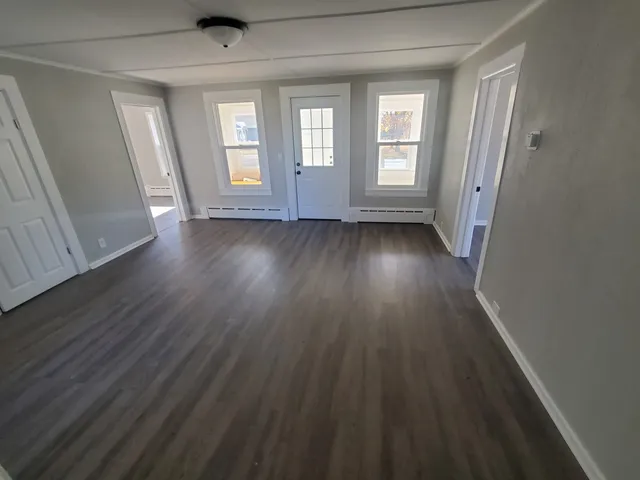 wooden floor in an empty room with a window