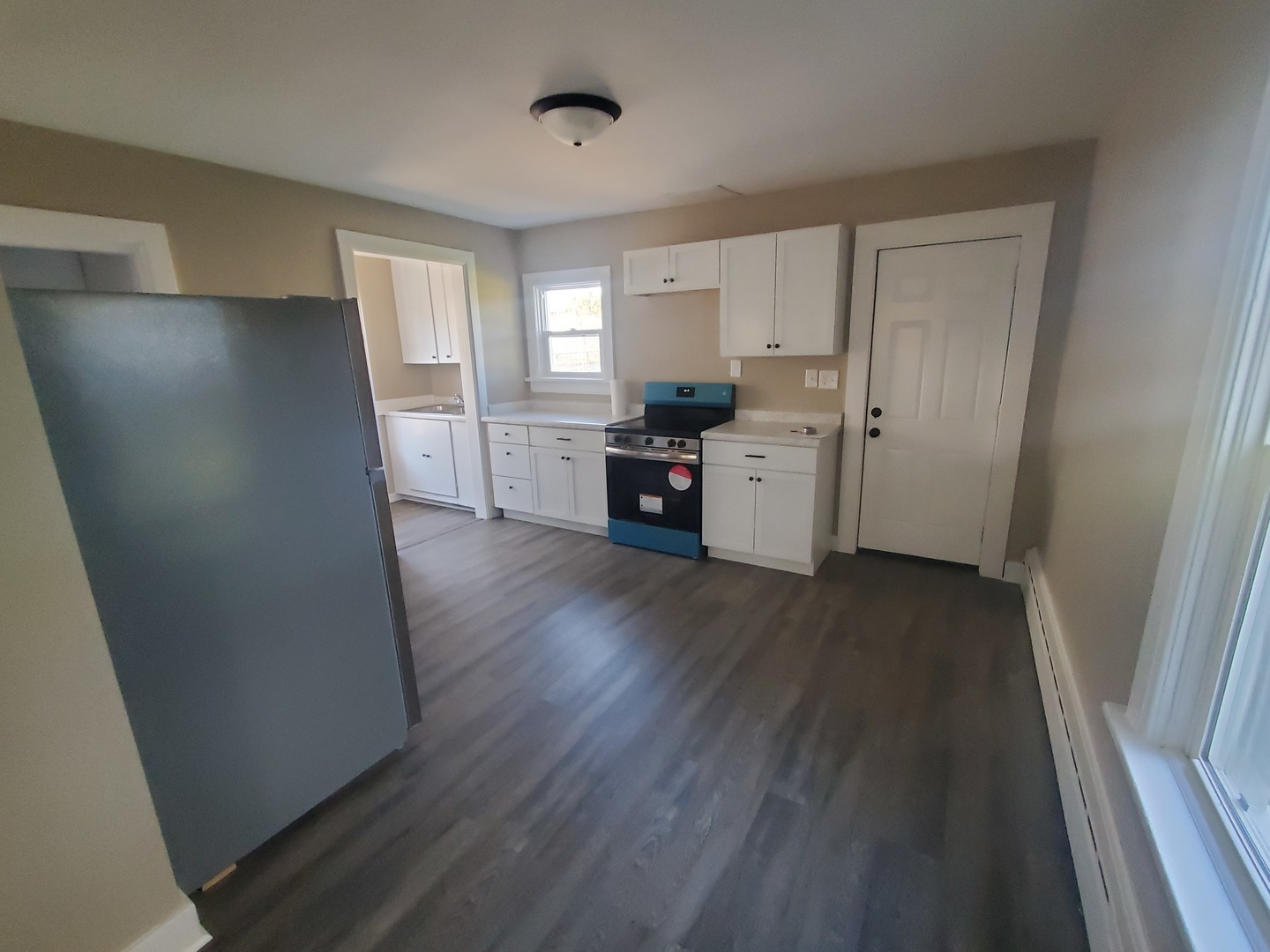 11606 Prairie Avenue Hebron, IL 60034 - Photo 9 of 14 a view of a kitchen with wooden floor and electronic appliances