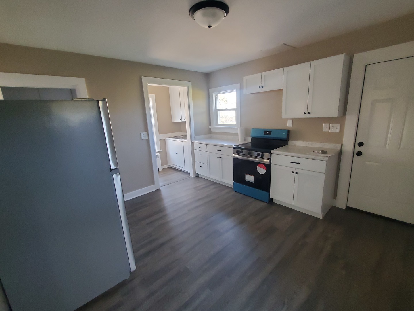 11606 Prairie Avenue Hebron, IL 60034 - Photo 10 of 14 a kitchen with white cabinets and wooden floor