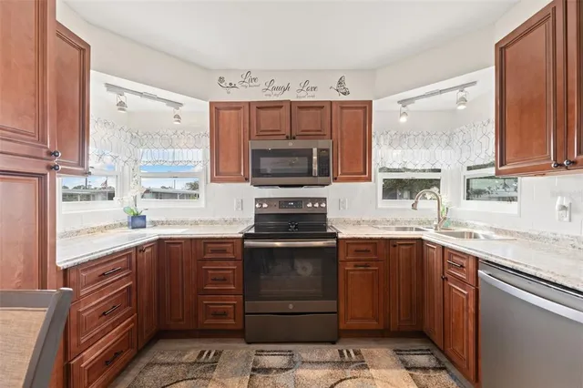 a kitchen with a sink stove and microwave