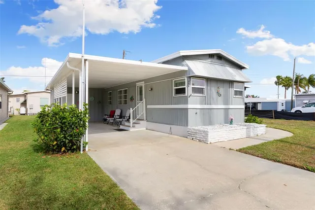 a view of a house with backyard porch and sitting area