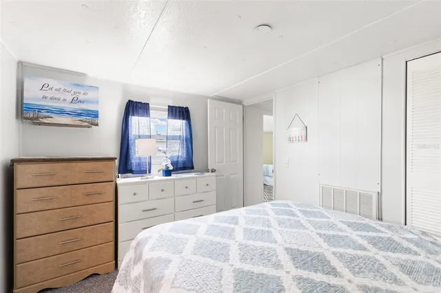 a bedroom with a bed and a dresser