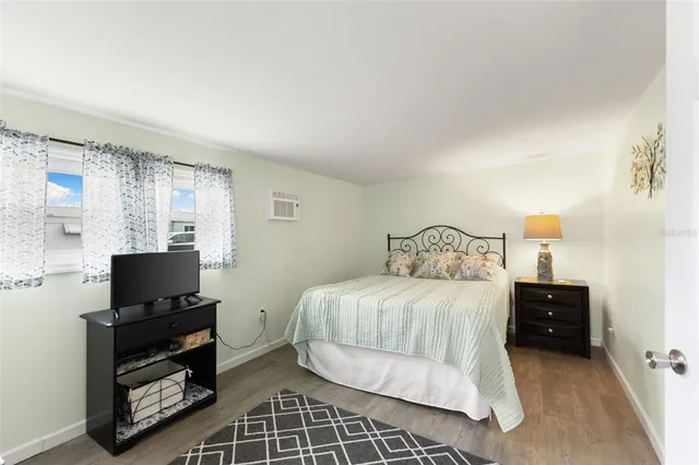 a bedroom with a bed and a tv