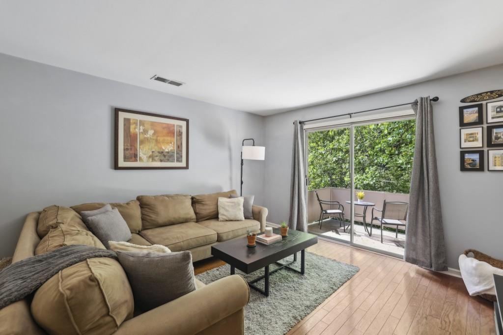 5400 Roswell Road, Unit H5 Atlanta, GA 30342 - Photo 1 of 26 a living room with furniture and a large window