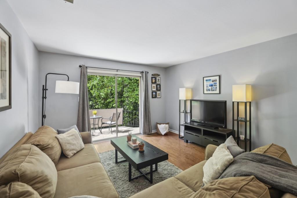 5400 Roswell Road, Unit H5 Atlanta, GA 30342 - Photo 13 of 26 a living room with furniture and a flat screen tv